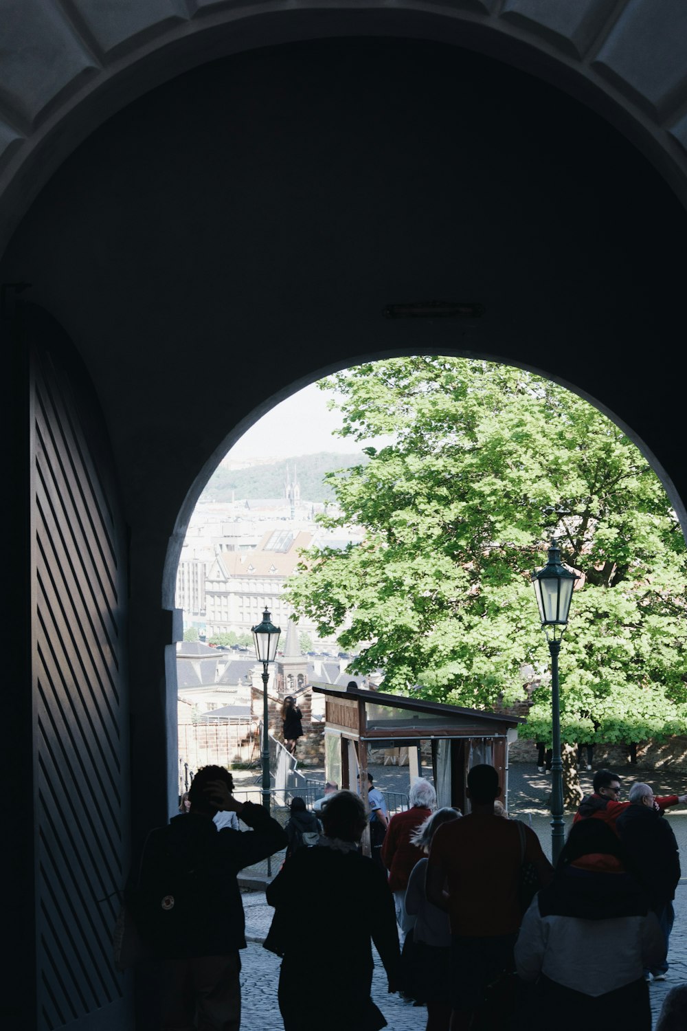 a group of people walking under an archway