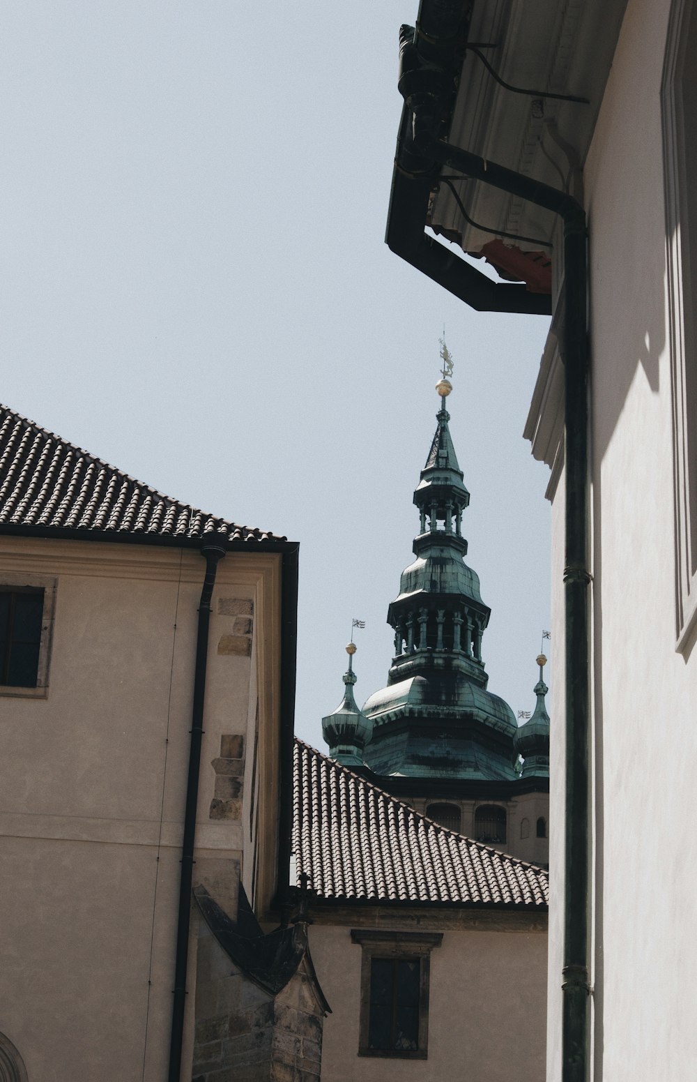 a view of a building with a steeple in the background