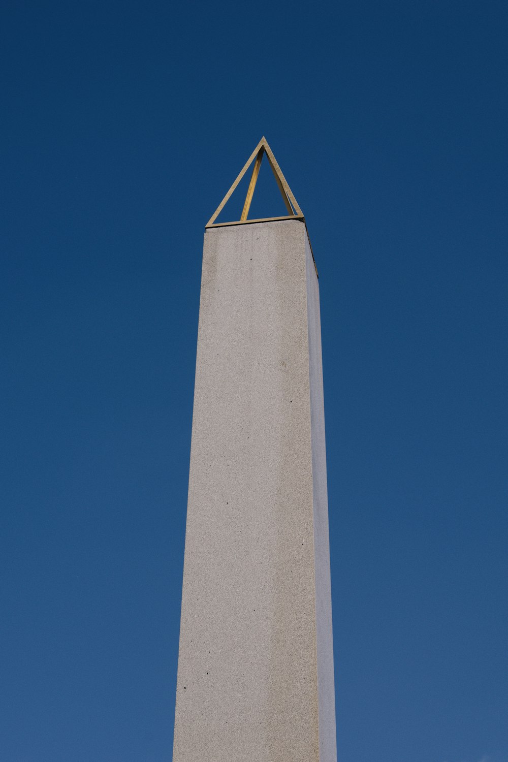 a tall white monument with a clock on it's side