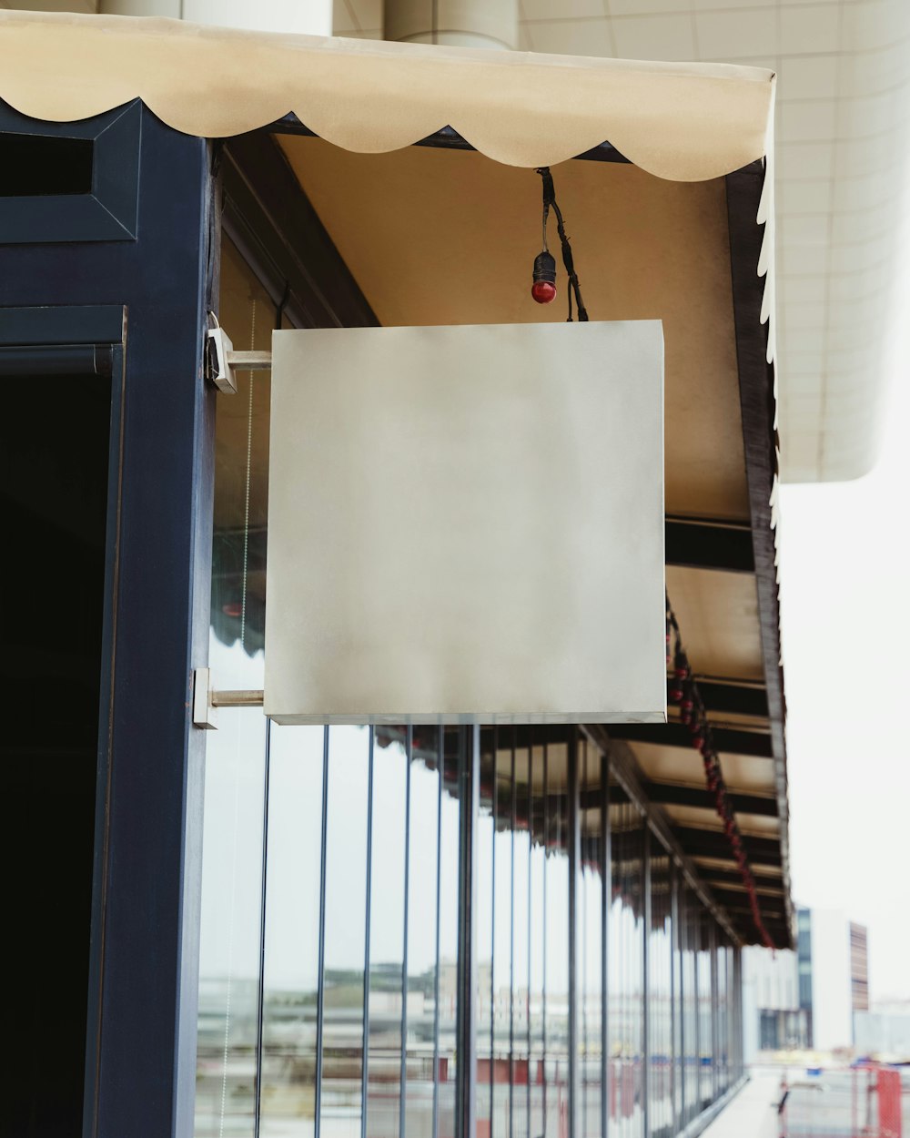 a white sign hanging from the side of a building