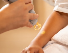 a woman getting her nails done at a nail salon