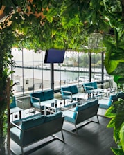 A peaceful waterfront terrace with modern seating and lush greenery.
