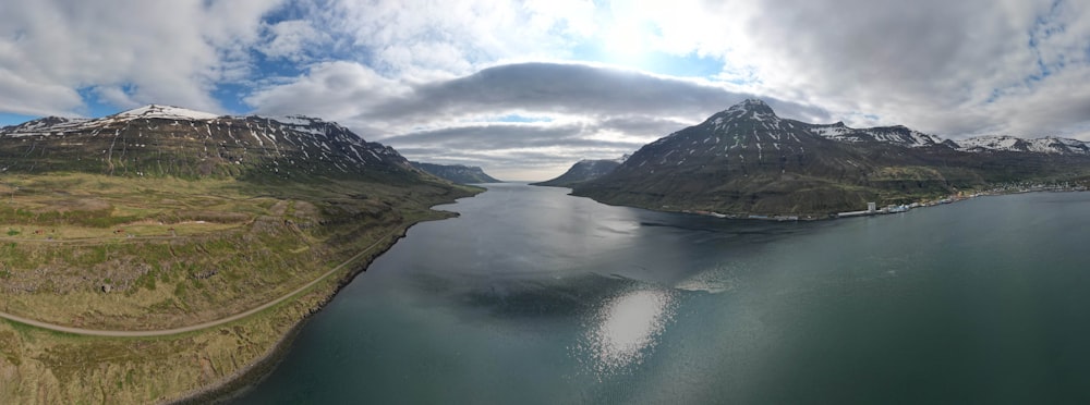 an aerial view of two mountains and a body of water