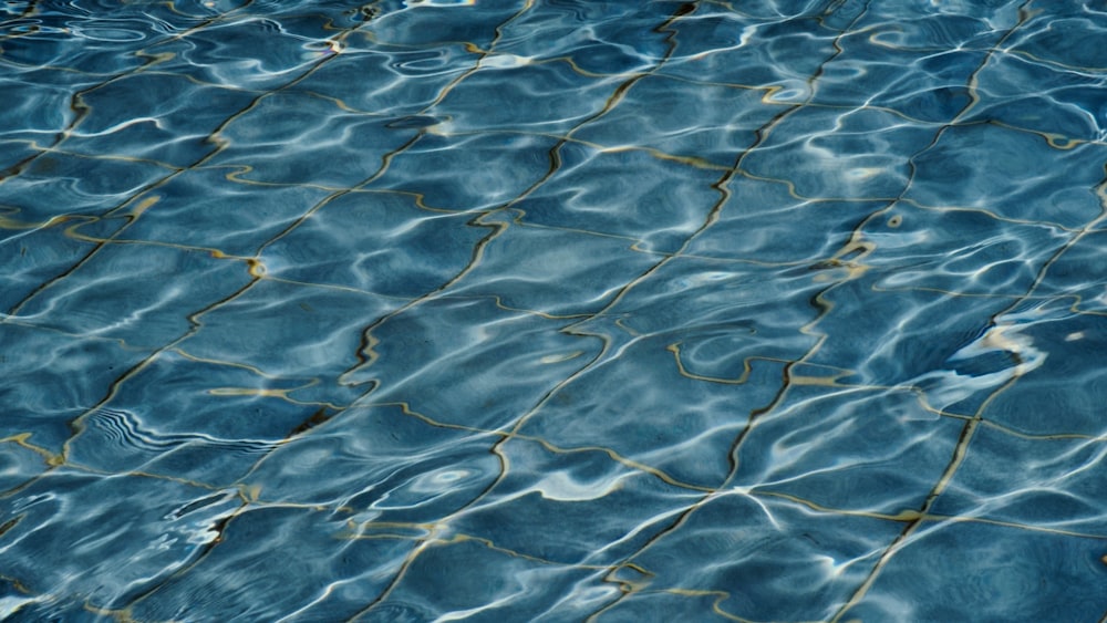 a close up of a pool with blue water