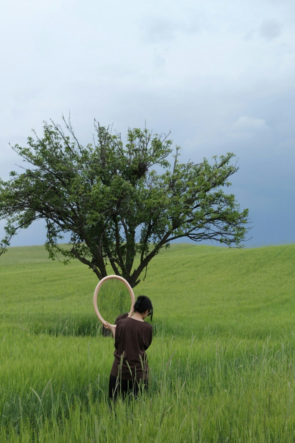 a person standing in a field with a frisbee