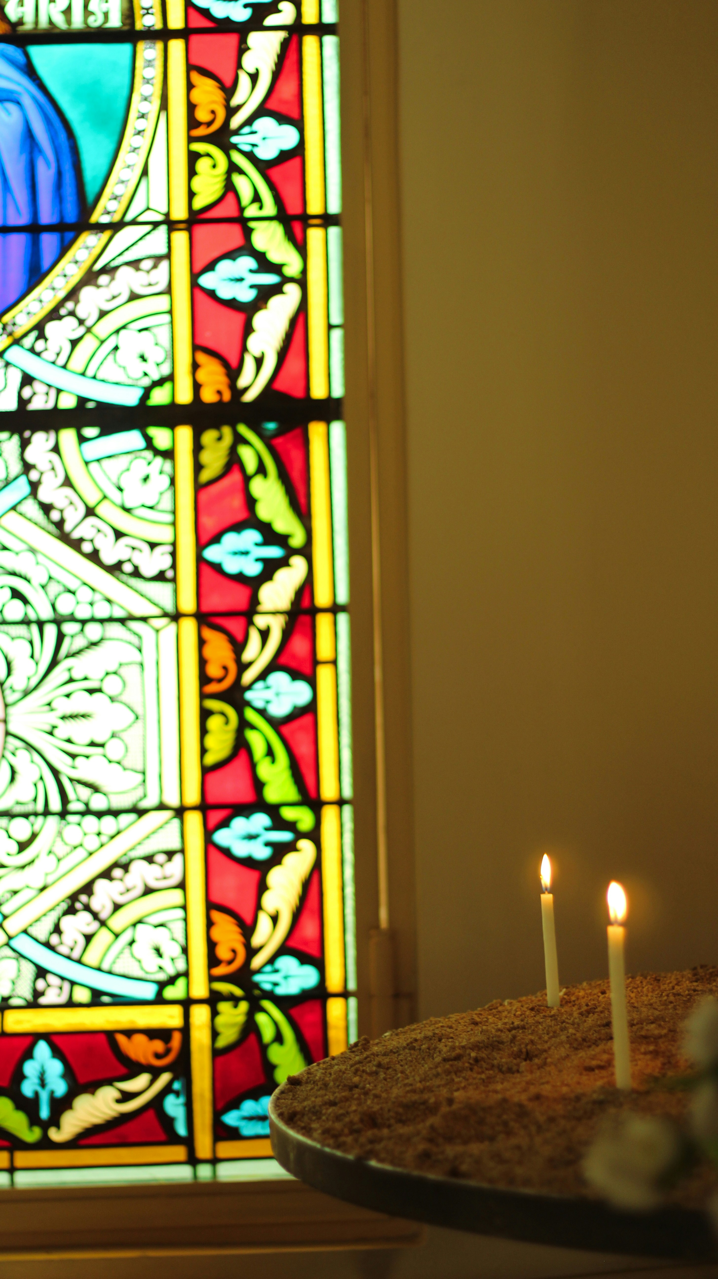 A cake sitting in front of a stained glass window photo – Free Art ...