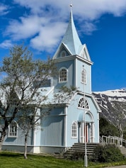 a church with a steeple and a steeple on the side of it