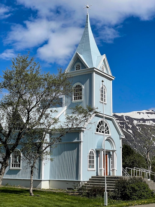 a church with a steeple and a steeple on the side of it