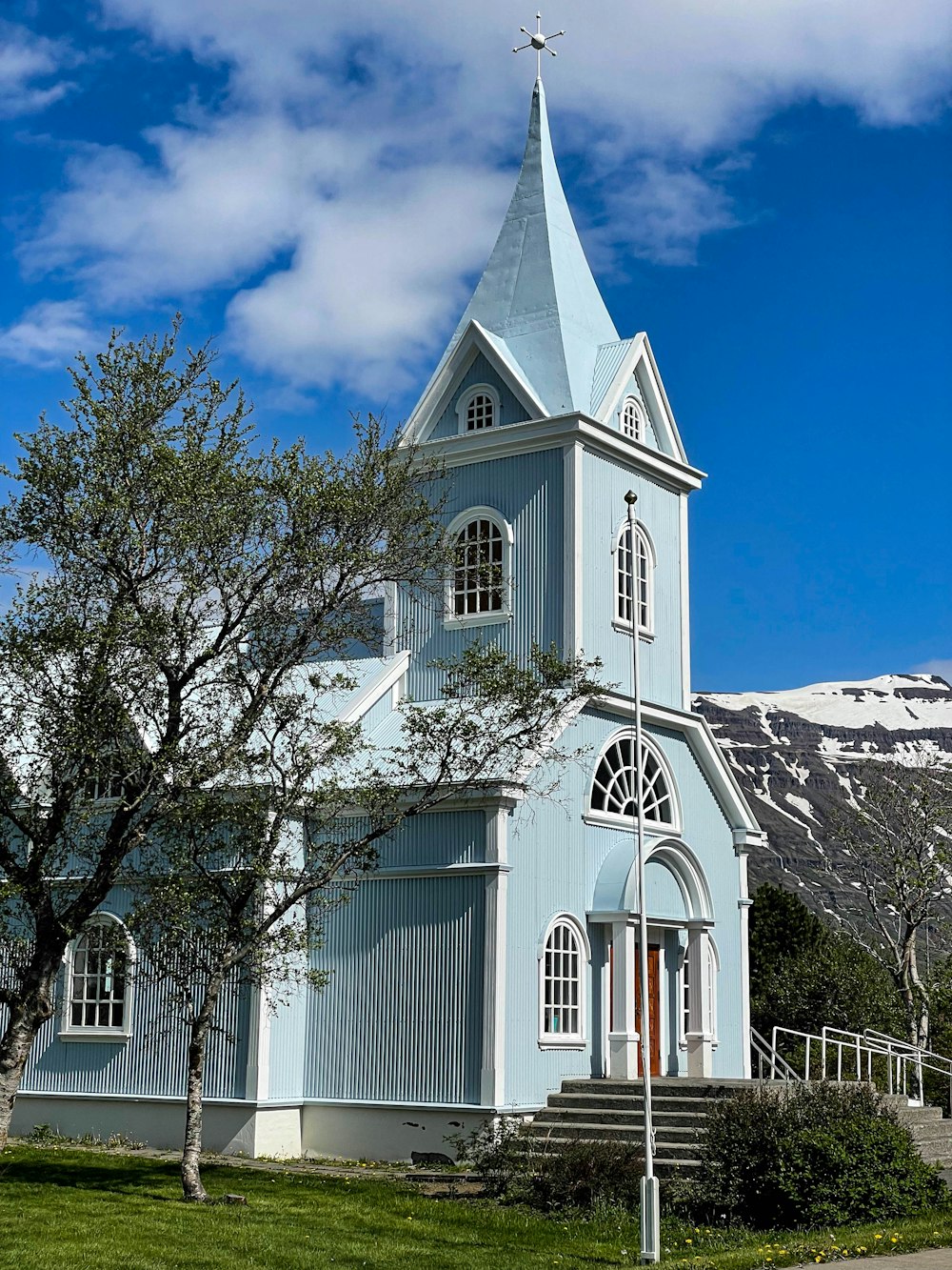 a church with a steeple and a steeple on the side of it