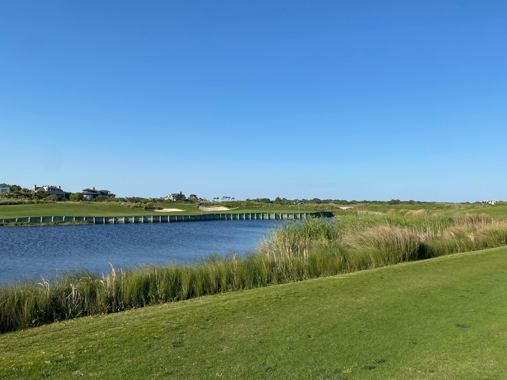 a view of a golf course with a bridge in the distance
