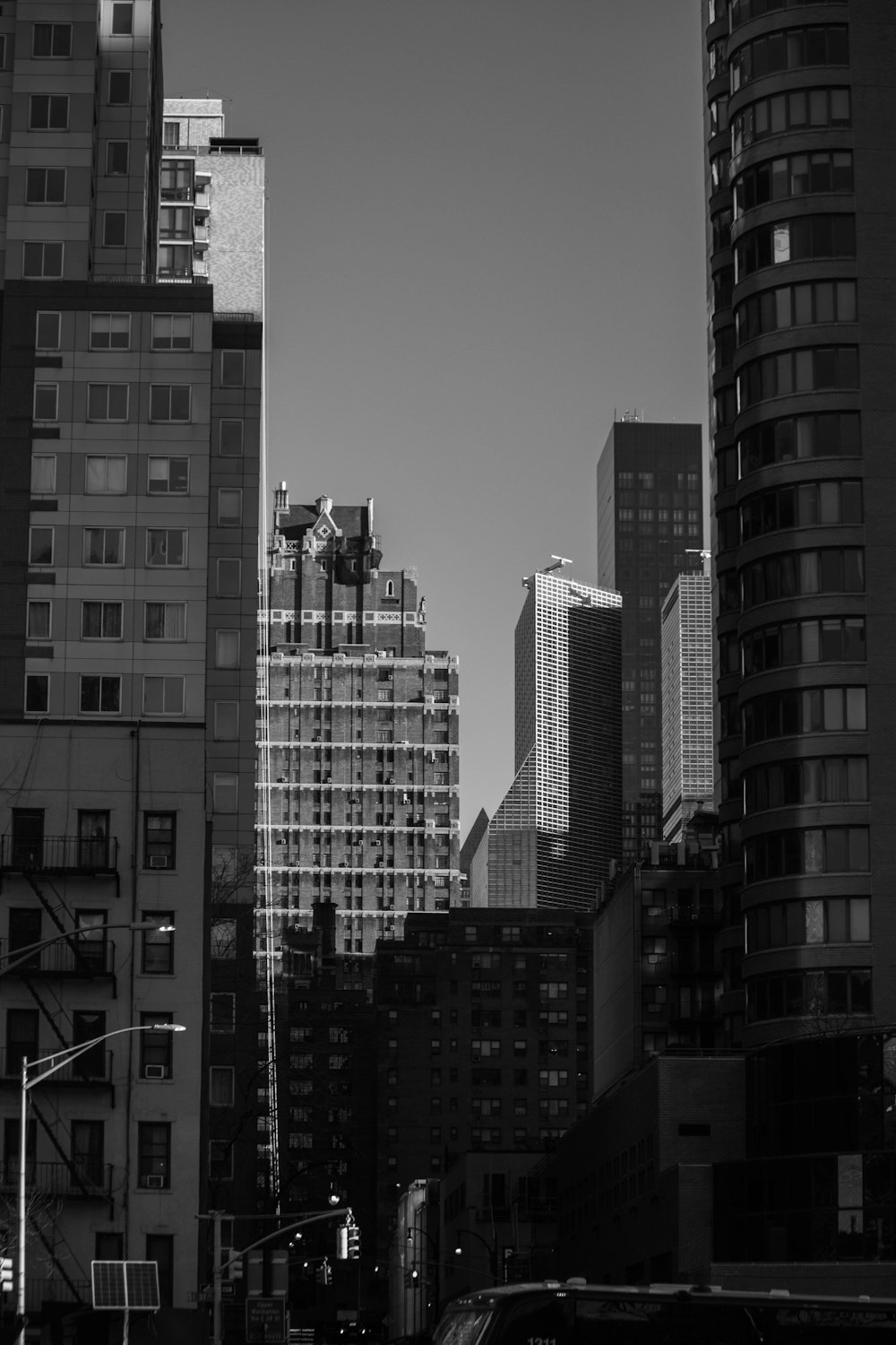 a black and white photo of a city with tall buildings