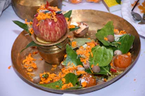 Close-up of sacred samagri items arranged neatly on a brass plate ready for a havan.