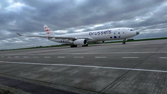 A sleek private taxi waiting outside Brussels Zaventem airport with a friendly driver.