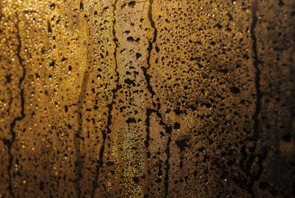 Close-up of a sparkling clean shower glass with water droplets reflecting light.
