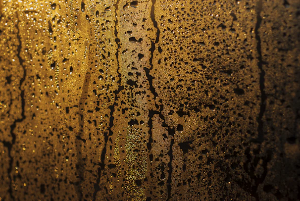 Close-up of a sparkling clean shower glass with water droplets reflecting light.