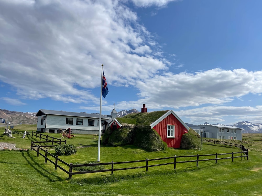 a red house with a flag on top of it