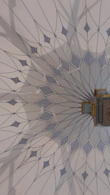 An elegant depiction of a vastu layout plan with golden lines and mandala patterns on a deep blue background.