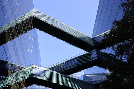 Modern office building with interconnected glass corridors symbolizing integrated business operations.