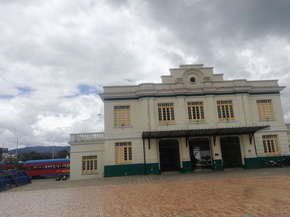 a large white building sitting on top of a brick road