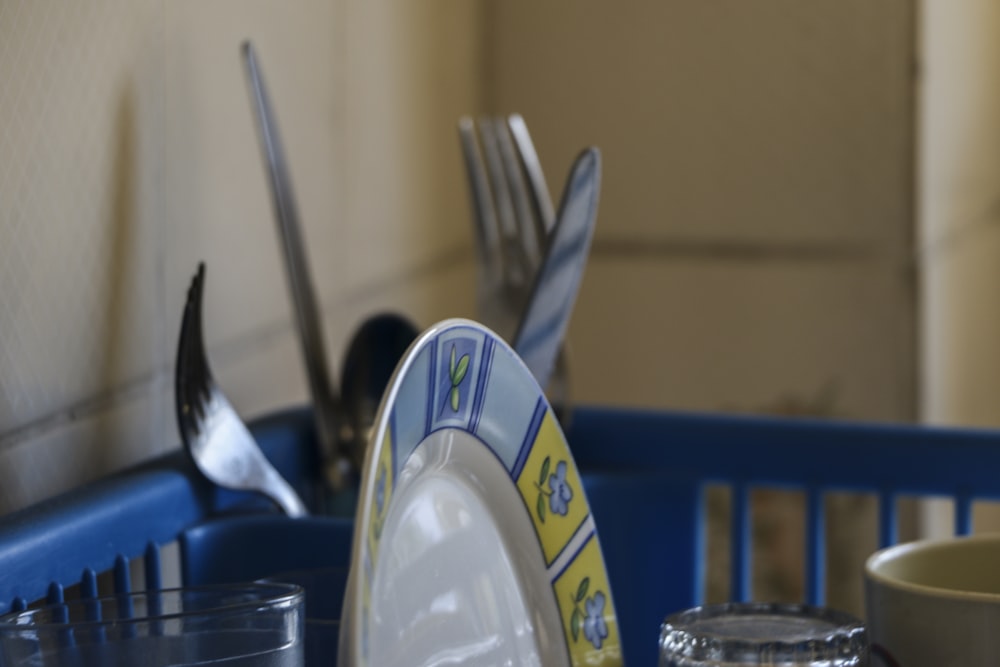 a close up of a plate with forks and spoons