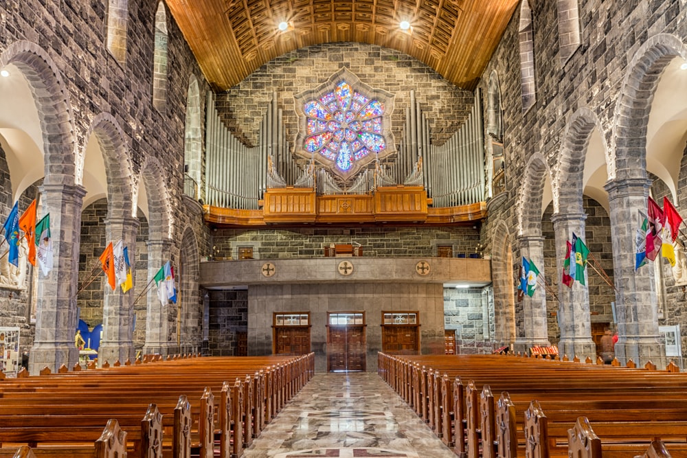 a church with pews and stained glass windows