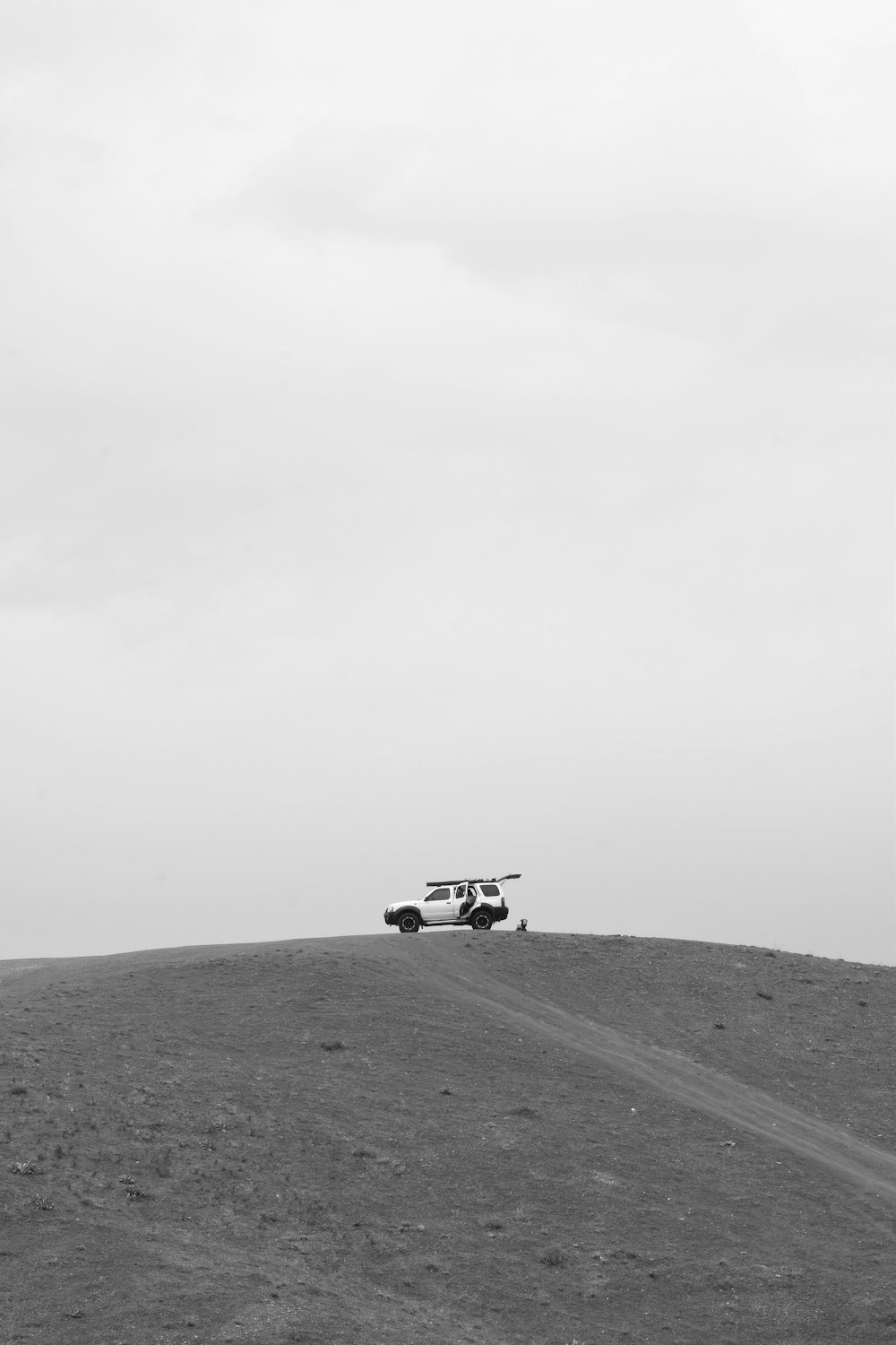 a plane is flying over a hill on a cloudy day