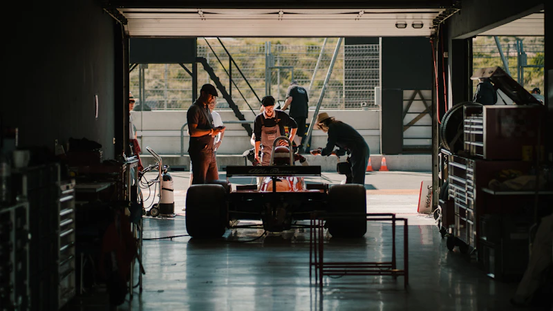 Engineers working on a race car in the garage