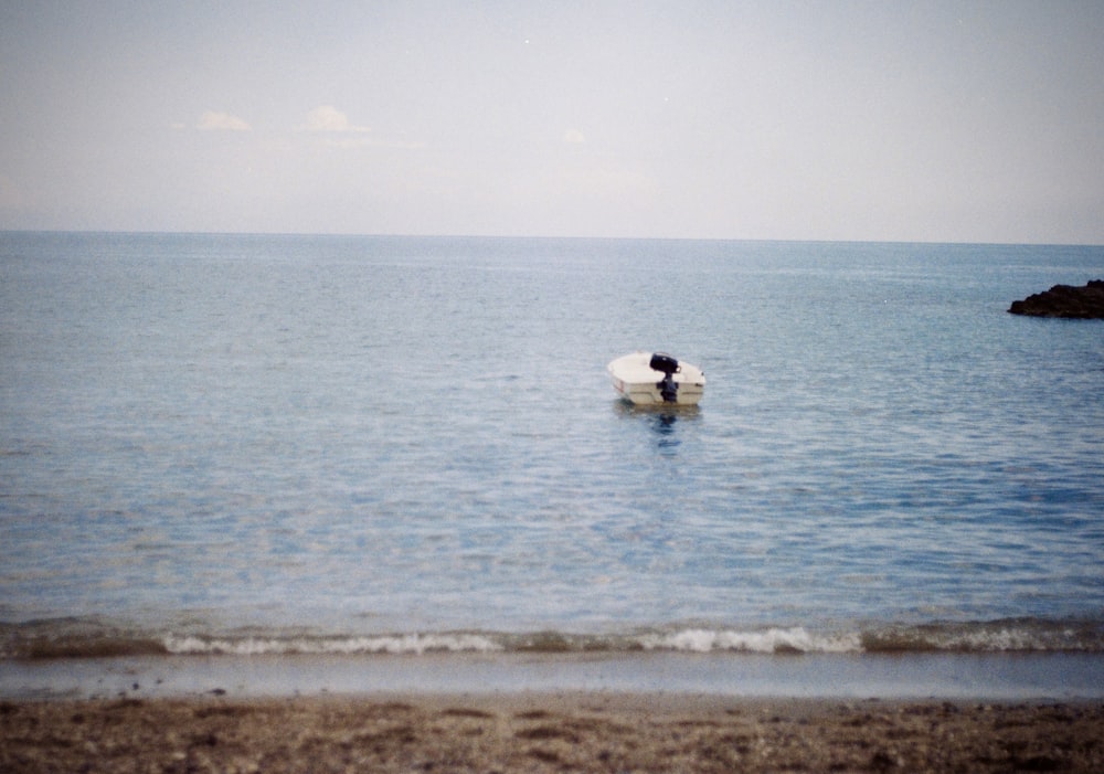 a person sitting on a surfboard in the ocean