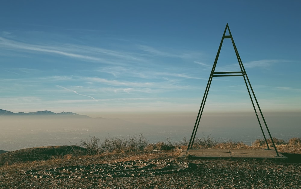 a wooden sign sitting on top of a hill