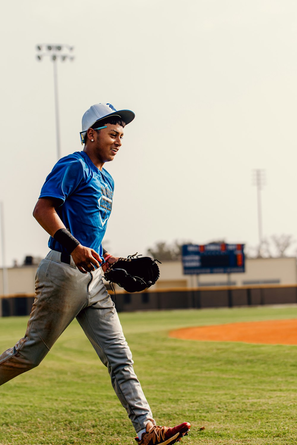 a baseball player is running on the field