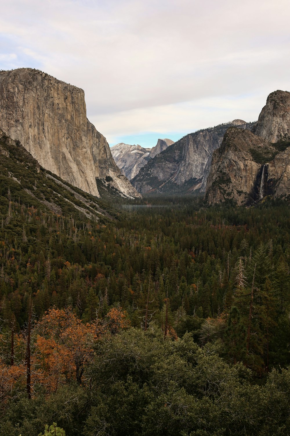 a view of a valley with mountains in the background