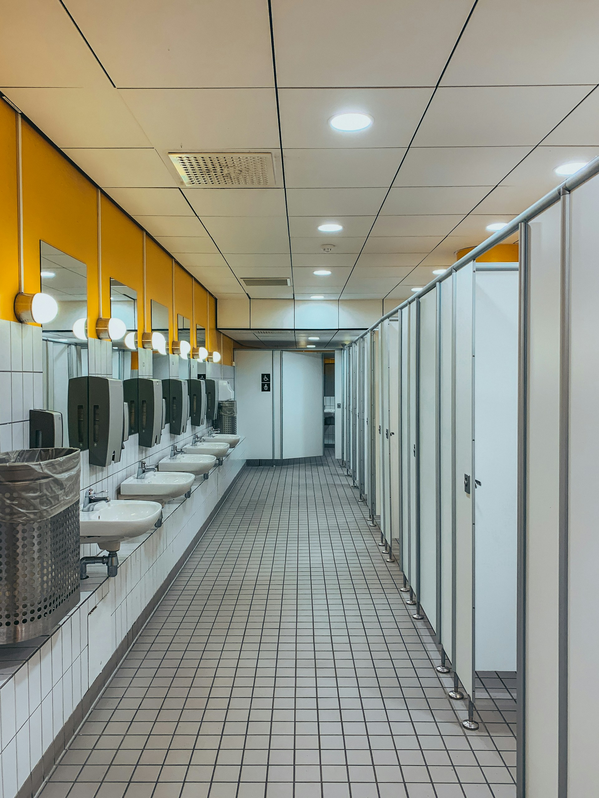 woman wearing yellow long-sleeved dress under white clouds and blue sky during daytime