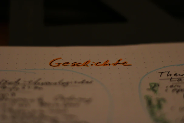Close-up of a worksheet filled with handwritten German exercises and notes, showcasing focused learning.