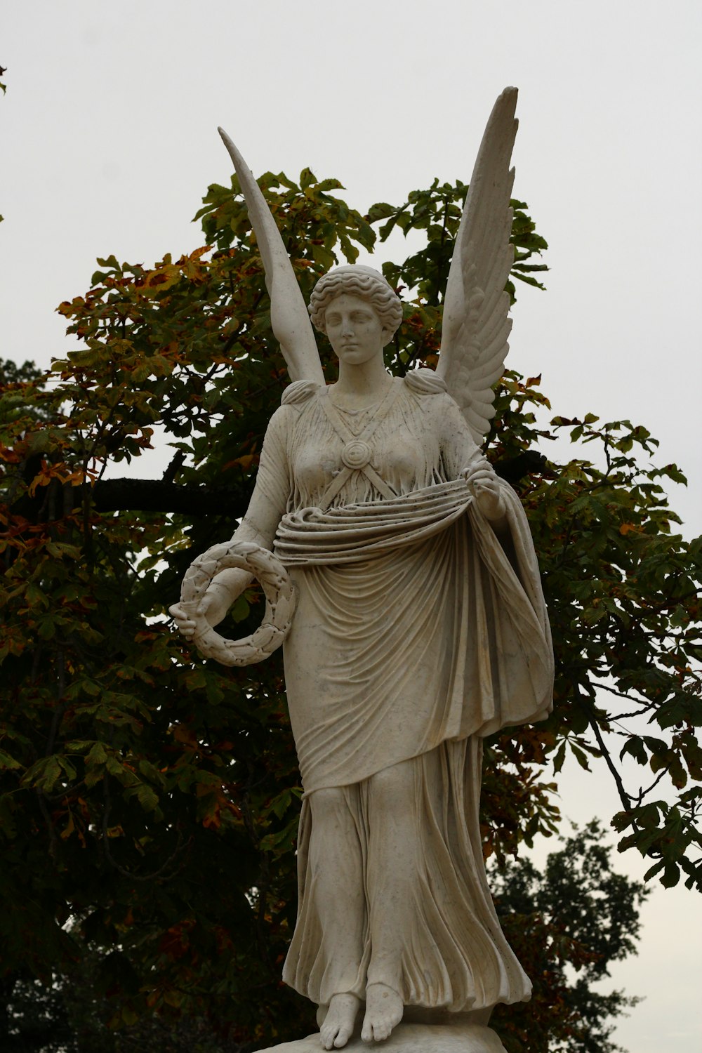une statue d’un ange tenant un panier