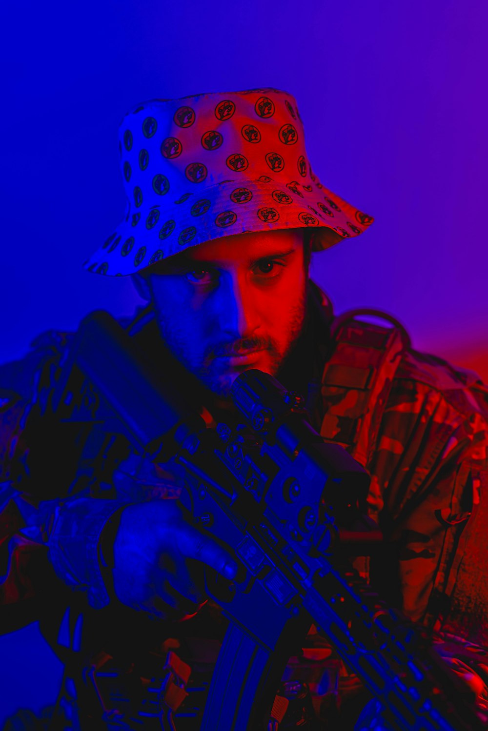 a man in a hat holding a machine gun