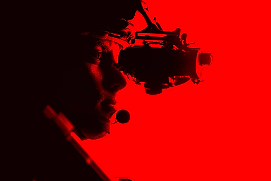 A sleek tactical operator using a SilentNode device in an urban environment.