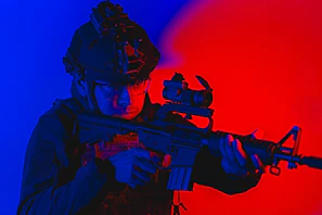 A focused instructor demonstrating firearm safety to attentive students in a modern training room.