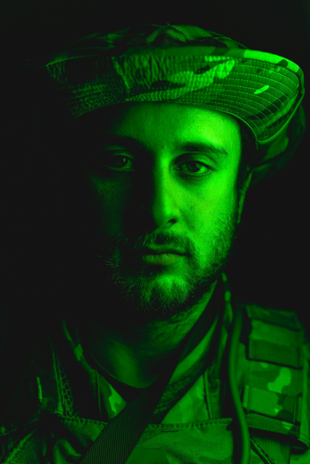 a man wearing a hat and a green light
