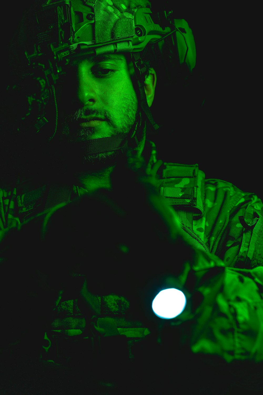 a man in a military uniform holding a flashlight
