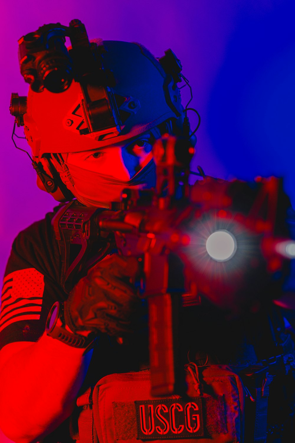 a man wearing a helmet and holding a gun