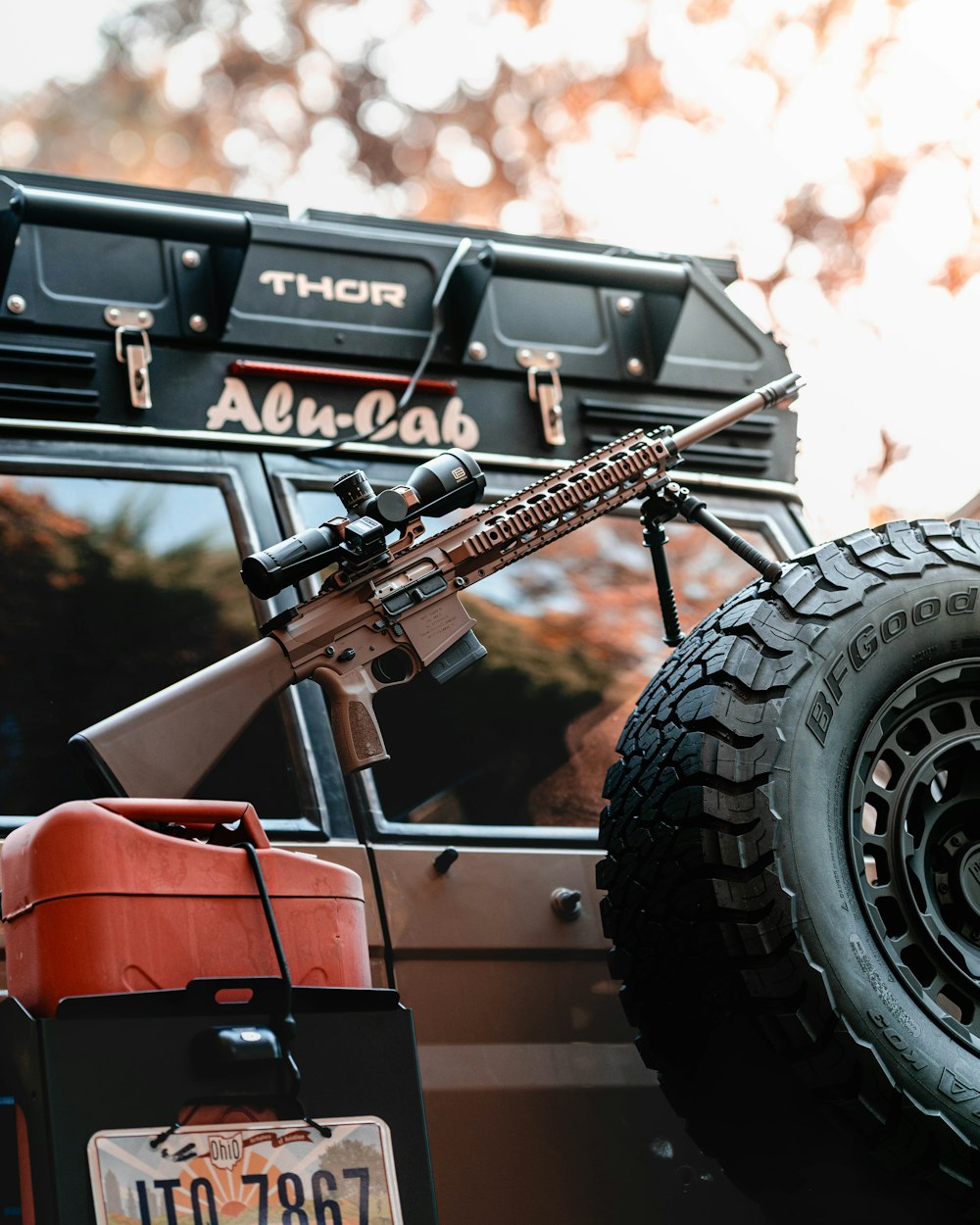 a jeep with a gun strapped to the front of it