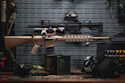 a rifle on a table next to other items