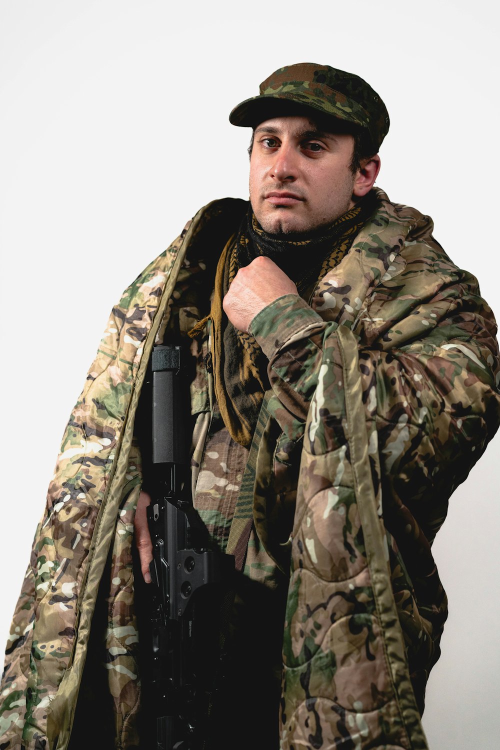 a man in a camouflage jacket holding a gun