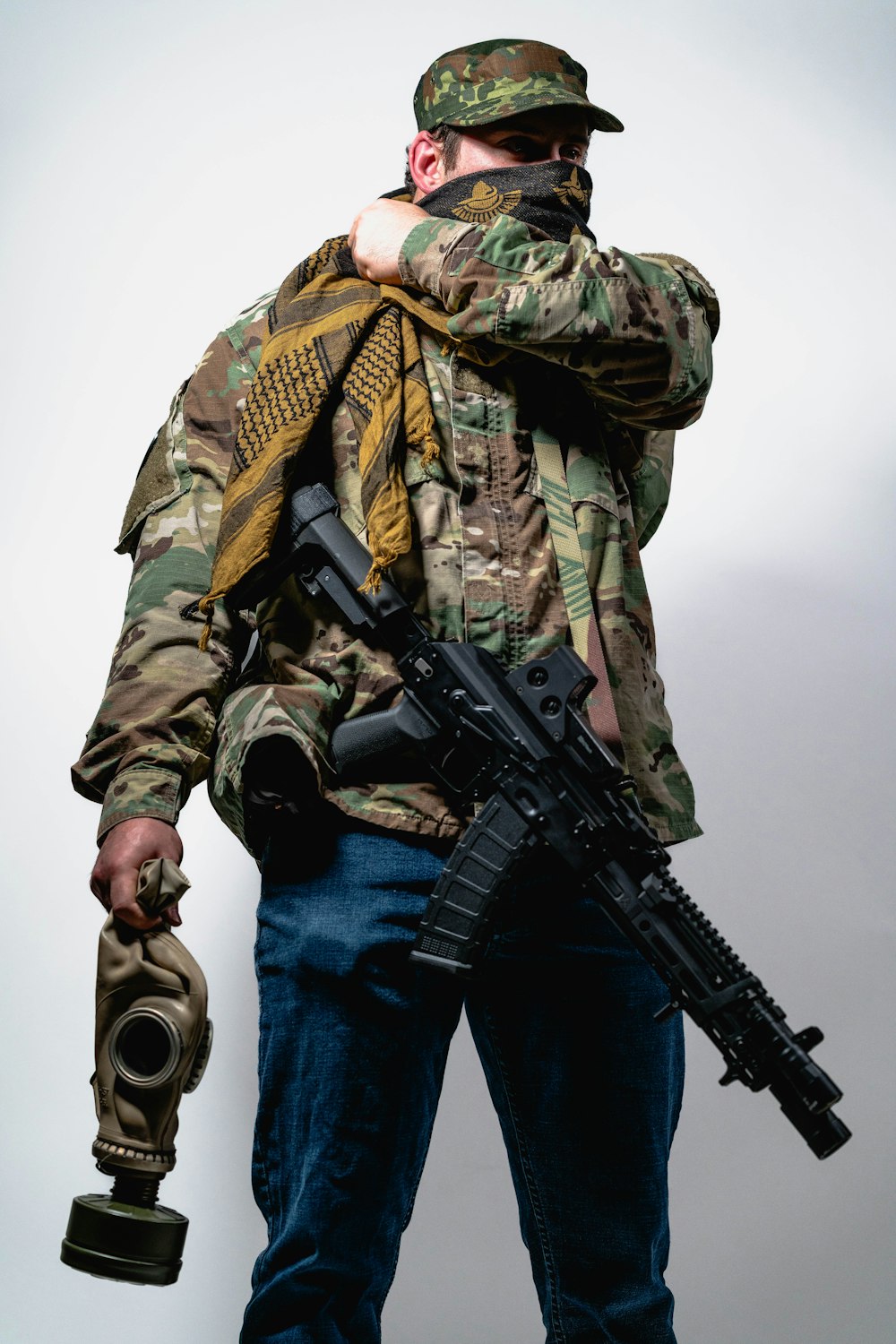 a man in camouflage holding a machine gun