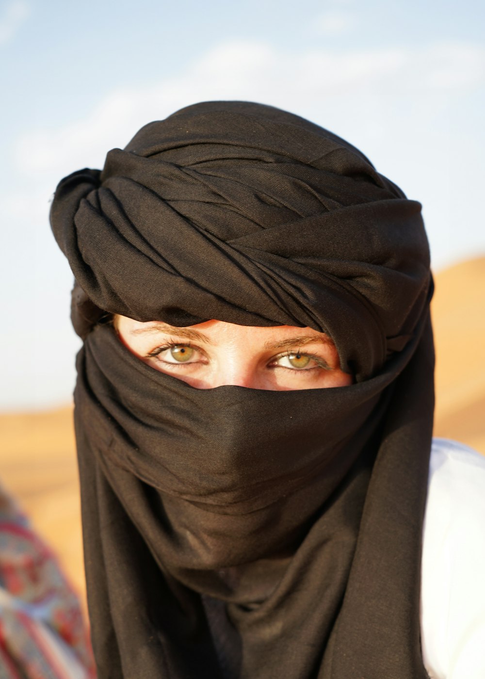 a woman wearing a black head covering over her face