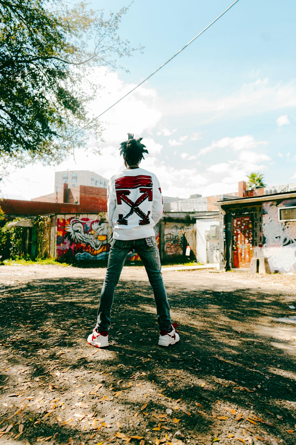 a person standing in the dirt with a skateboard