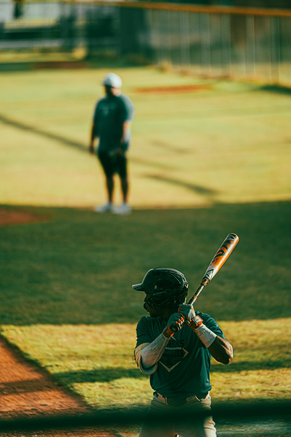 a baseball player holding a bat on a field