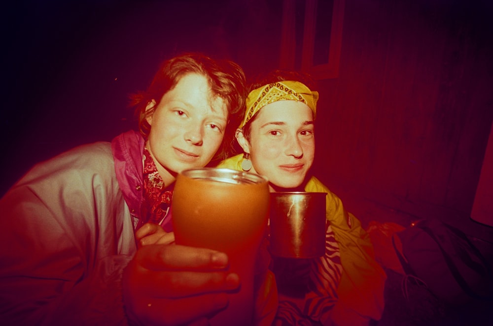 a couple of people that are holding a cup
