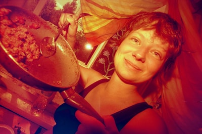 Happy person cooking a quick meal, smiling and enjoying the process.