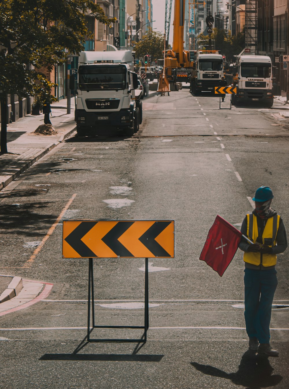 a construction worker holding a sign on a city street